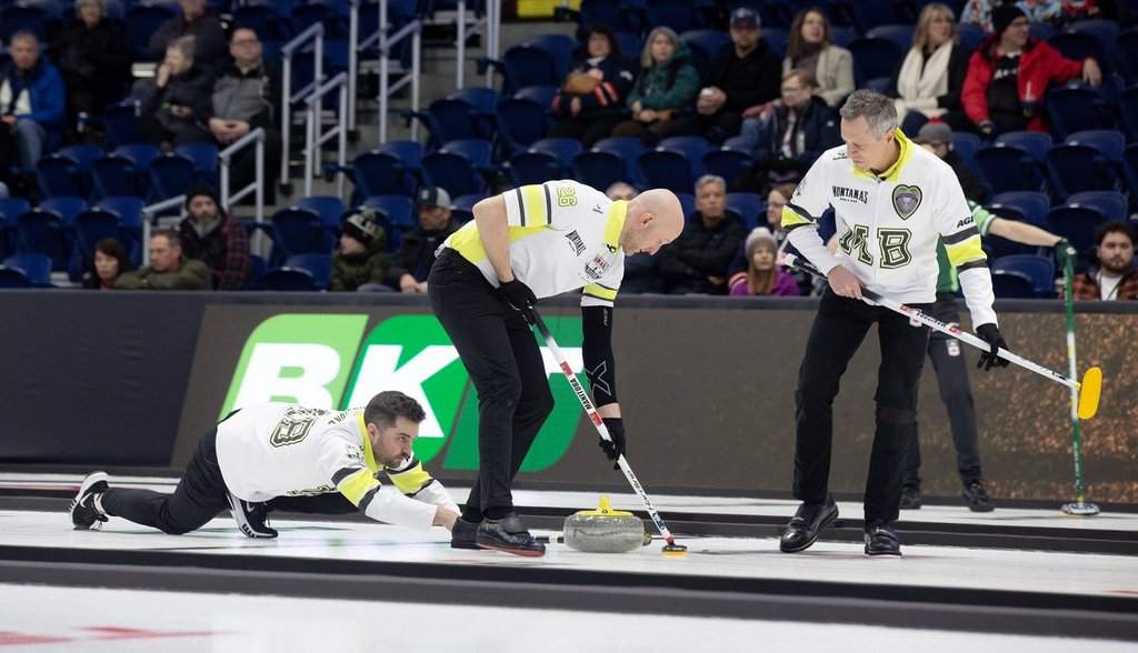 Manitoba's Matt Dunstone releases the stone as teammates Ryan Harnden and EJ Harnden sweep the stone during Draw 8 the Montana's Brier in St. John's, N.L., on March 2, 2026. THE CANADIAN PRESS/Paul Daly.