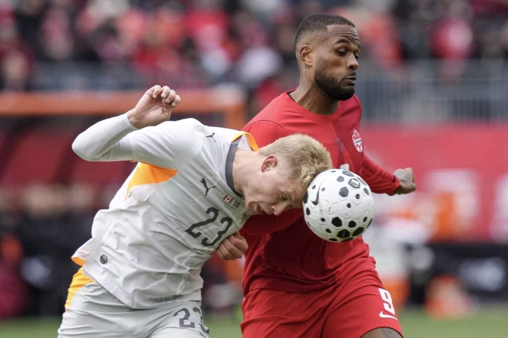 Iceland defender Hordor Bjorgvin Magnusson clears the ball away from Canadian striker Cyle Larin in Toronto on Saturday, March 28, 2026. THE CANADIAN PRESS/Chris Young.