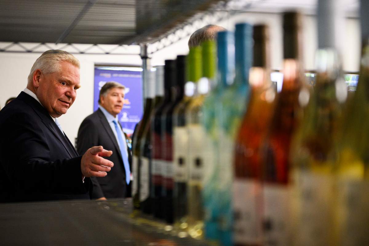 Ontario Premier Doug Ford gestures to a display of alcoholic beverages after an announcement saying the province is speeding up the expansion of alcohol sales, in Toronto on May 24, 2024.