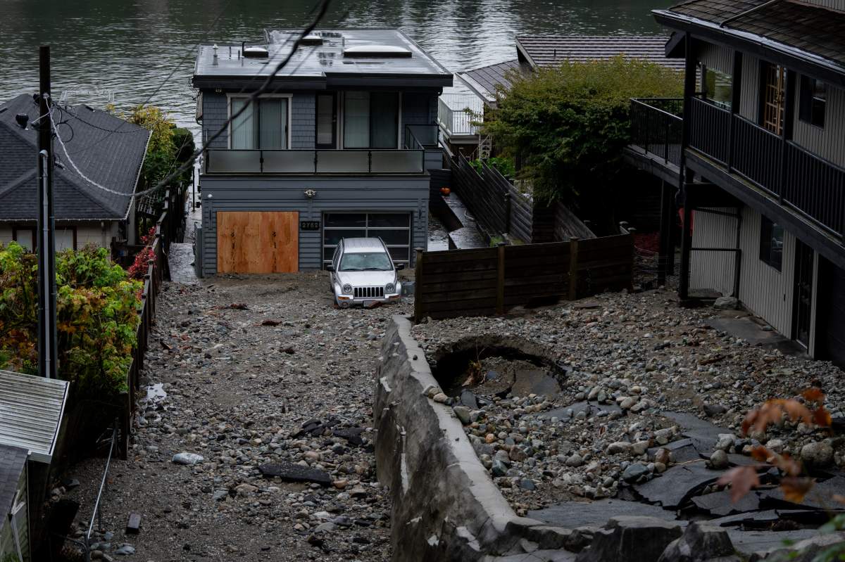Coastal British Columbia will see strong winds overnight with gusts that could reach speeds of 90 kilometres per hour or higher in some areas. Multiple homes are seen surrounded by debris left by flooding from torrential rain from an atmospheric river weather system at Deep Cove in North Vancouver, on Tuesday, October 22, 2024.