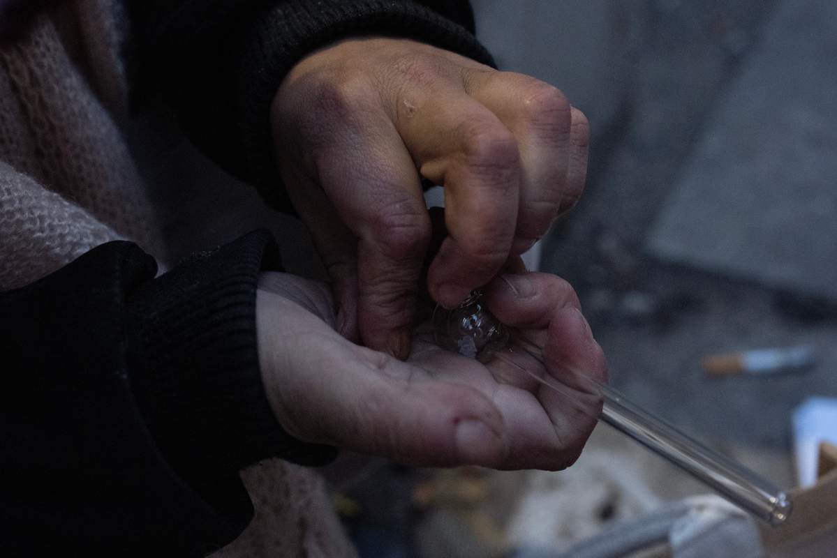 A person loads a bowl before smoking opioids in Toronto on Nov. 4, 2025.