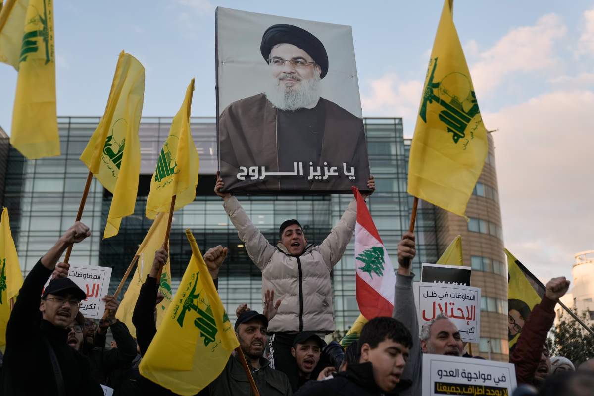Hezbollah supporters raise group's flags and image of late leader Hassan Nasrallah at protest in Beirut, Lebanon, Feb. 4, 2026. (AP Photo/Bilal Hussein).