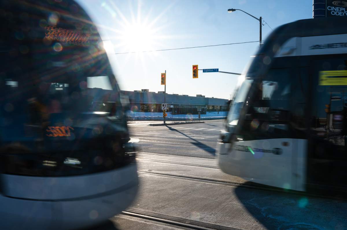 Two Eglinton Crosstown LRT trains pass each other on the transit line’s first day of service in Scarborough, Ont., on Feb. 8, 2026.
