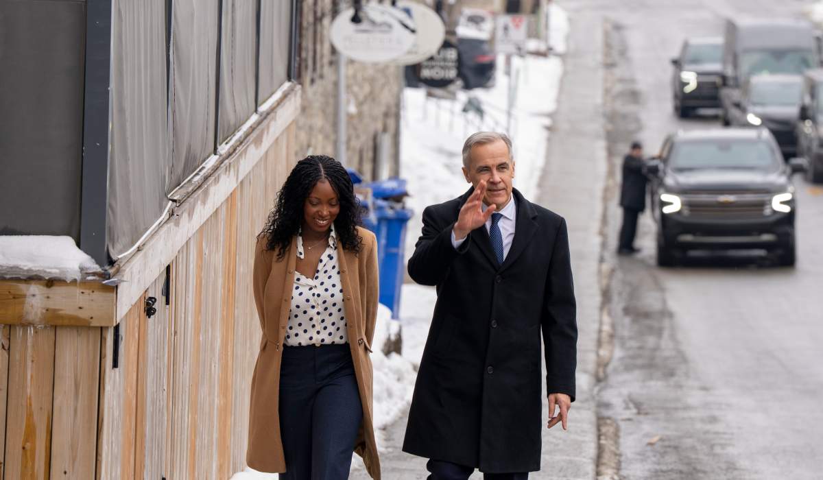 Prime Minister Mark Carney, right, and Terrebonne candidate Tatiana Auguste, walk in her riding in Terrebonne, Que., on Tuesday, Feb. 17, 2026.