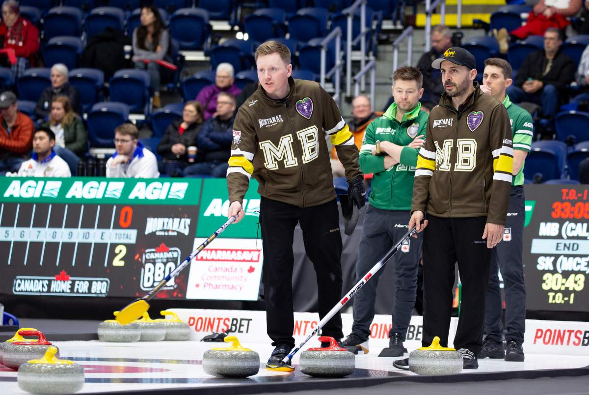 Team Manitoba-Calvert skip Braden Calvert and Vice-skip Corey Chambers discuss the call while Mike McEwen and Kevin Marsh of Team Saskatchewan-McEwen watch during Draw 14 at the Montana's Brier Canadian men's curling championship, in St. John's, N.L., on Wednesday, March 4, 2026. THE CANADIAN PRESS/Paul Daly.