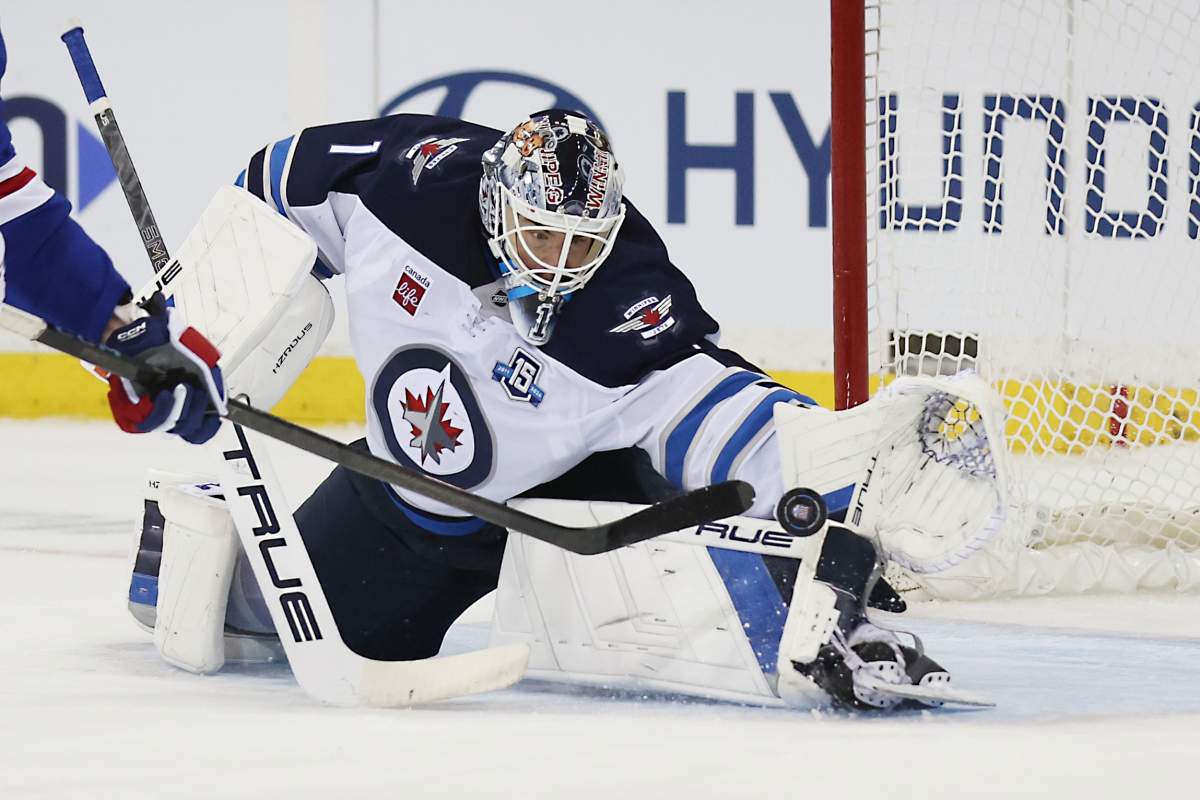 Jets goalie Eric Comrie makes a save