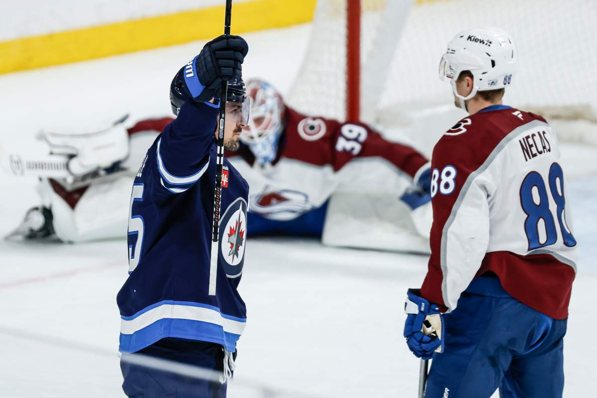 Winnipeg Jets' Mark Scheifele (55) celebrates his goal against Colorado Avalanche's goaltender Mackenzie Blackwood (39) and Martin Necas (88) during first period NHL action in Winnipeg, Thursday, March 26, 2026. THE CANADIAN PRESS/John Woods.