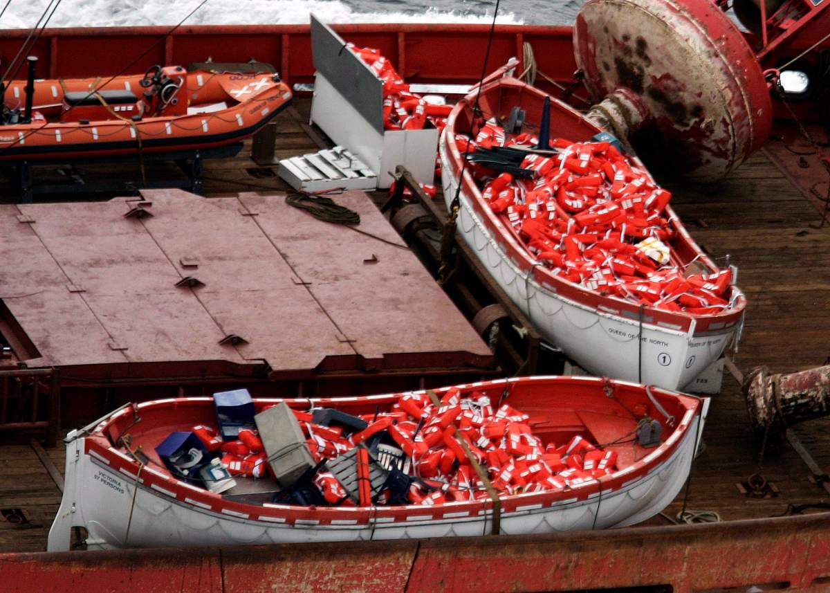 Lifeboats from the Queen of the North sit on the deck of the Canadian Coast Guard vessel Sir Wilfrid Laurier while en route to Prince Rupert, B.C., on March 22, 2006.