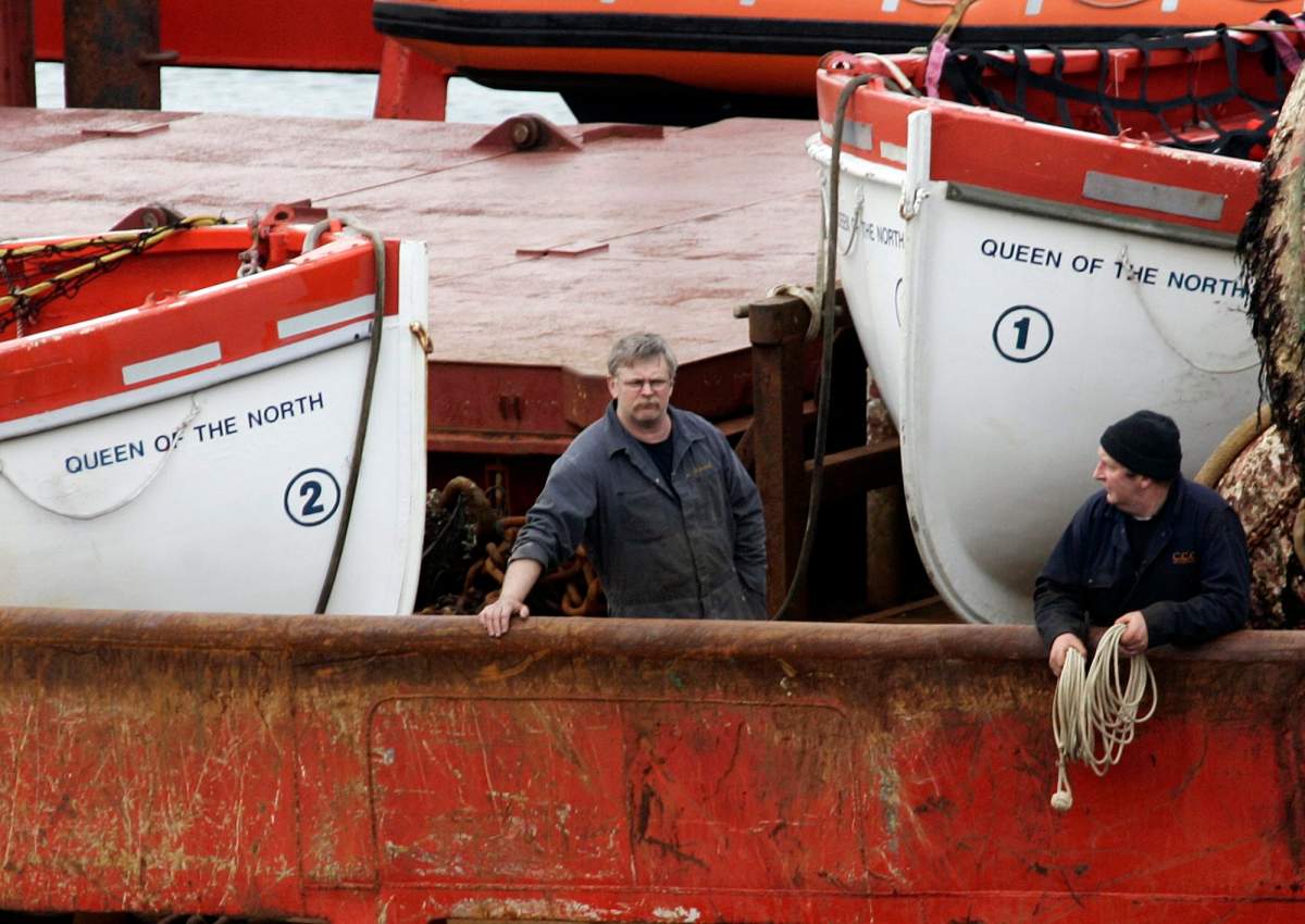 Crew members of the Canadian Coast Guard vessel Sir Wilfrid Laurier stands next to lifeboats used by passengers on board the Queen of the North ferry which sank in Prince Rupert, B.C., March 22, 2006.