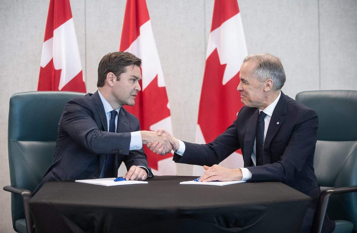 Prime Minister Mark Carney and MP Matt Jeneroux meet in Edmonton after Jeneroux crossed the floor to the Liberals on Feb. 18, 2026. THE CANADIAN PRESS/Jason Franson.