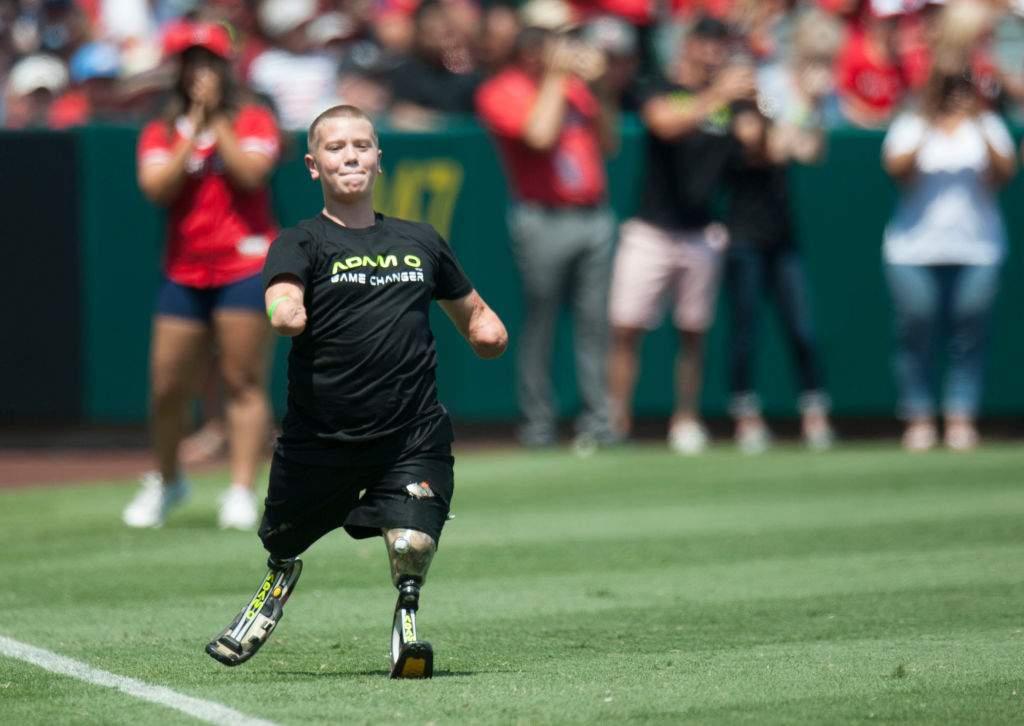 FILE - Dayton James Webber runs to steal third base at Angel Stadium on Sunday. Webber's prosthetic feet were donated by Game Changer Feet.