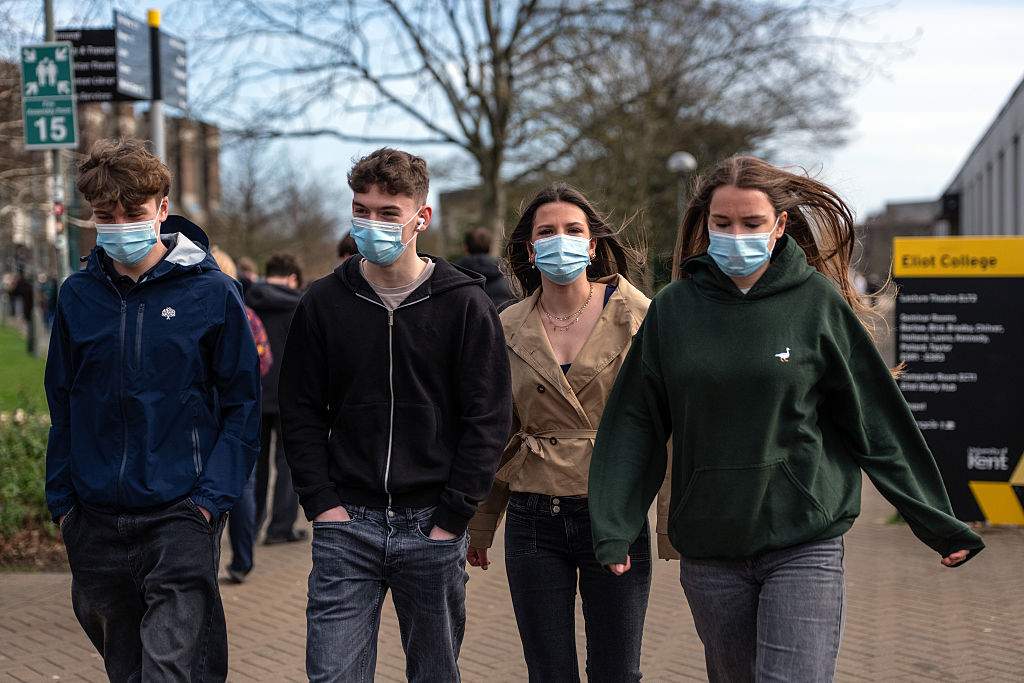 Students wearing face masks walk through the University of Kent in Canterbury campus after an outbreak of meningitis caused the deaths of two people, on March 16, 2026, in Canterbury, United Kingdom.
