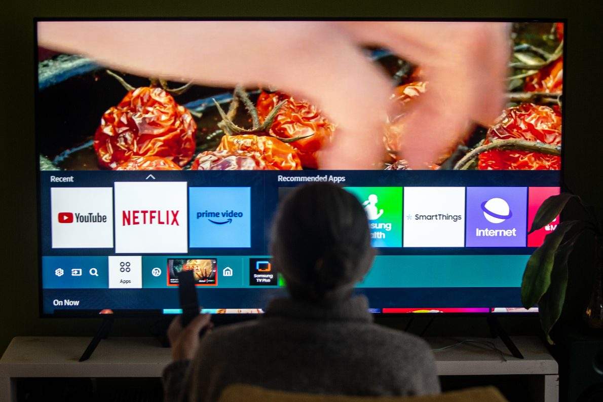A person browses a television menu showing icons for streaming services Netflix and Amazon Prime in a photo illustration made in Toronto on Friday, March 22, 2024. THE CANADIAN PRESS/Giordano Ciampini.