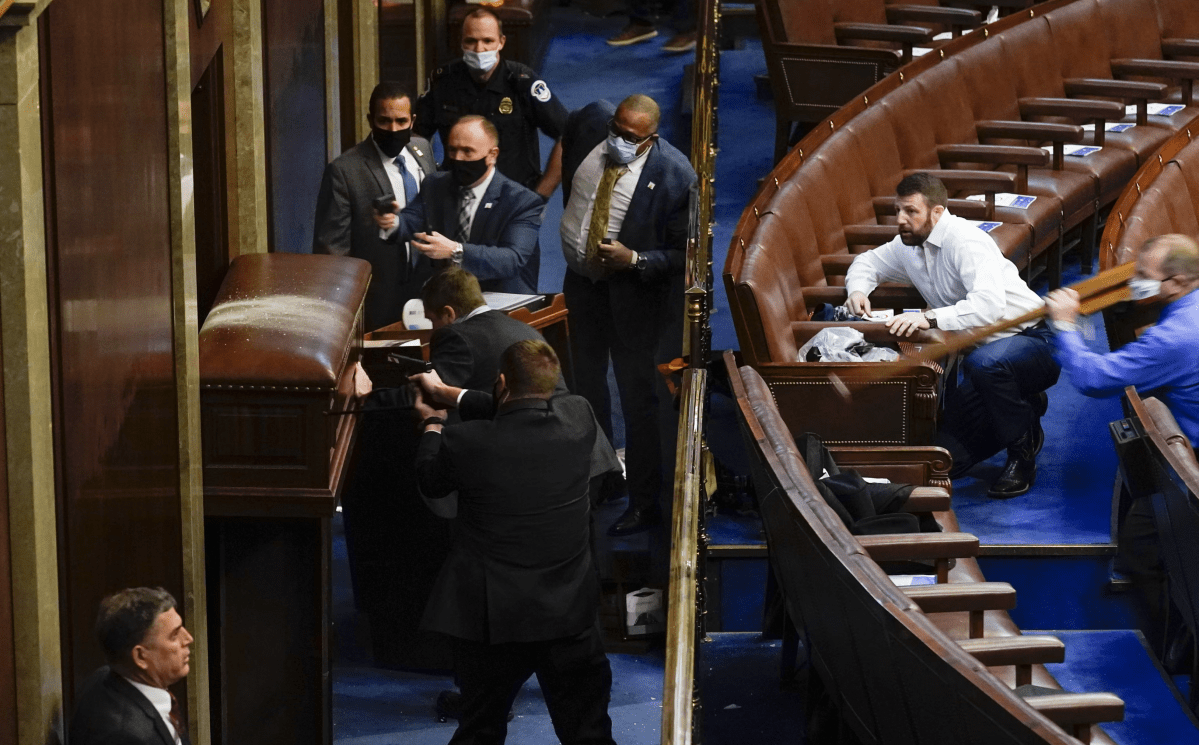 Markwayne Mullins is pictured ducking down in the House Chamber of the Capitol on Jan. 6, 2021.