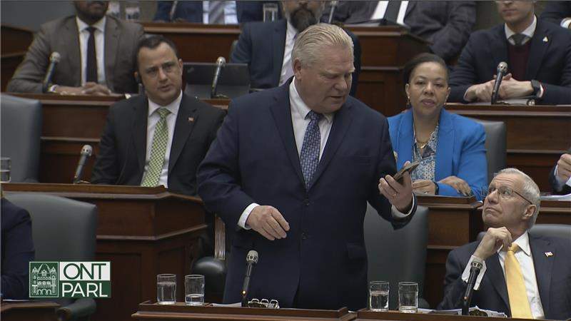 Doug Ford looks at his personal cellphone during Question Period.