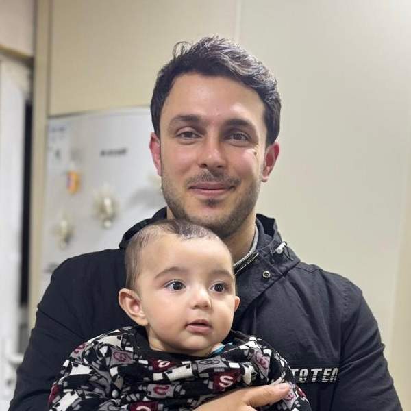Walat Tahir, holding his son, was killed in a Saturday drone strike, Erbil, Iraq, March 9, 2026.