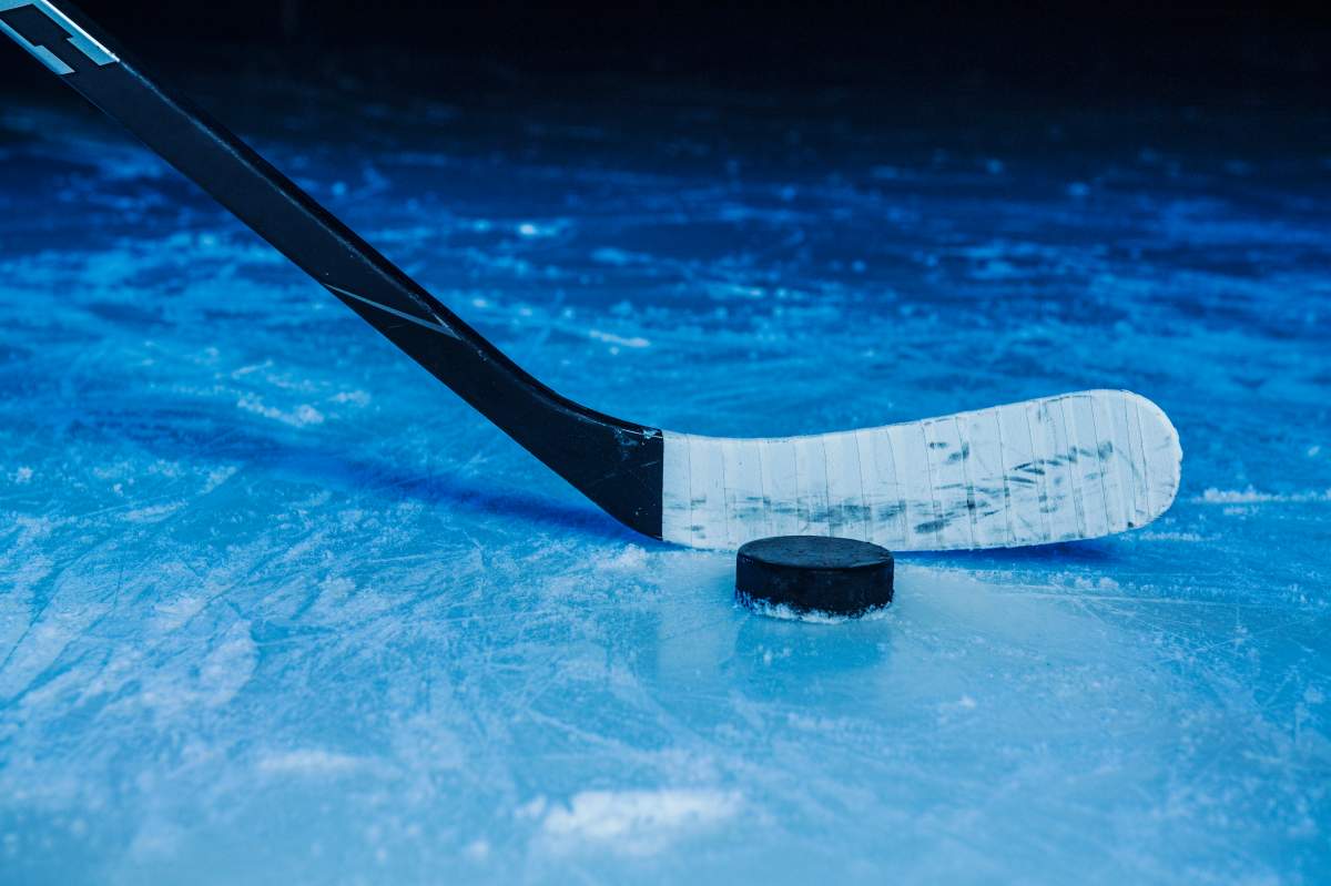 A hockey stick readies a shot.