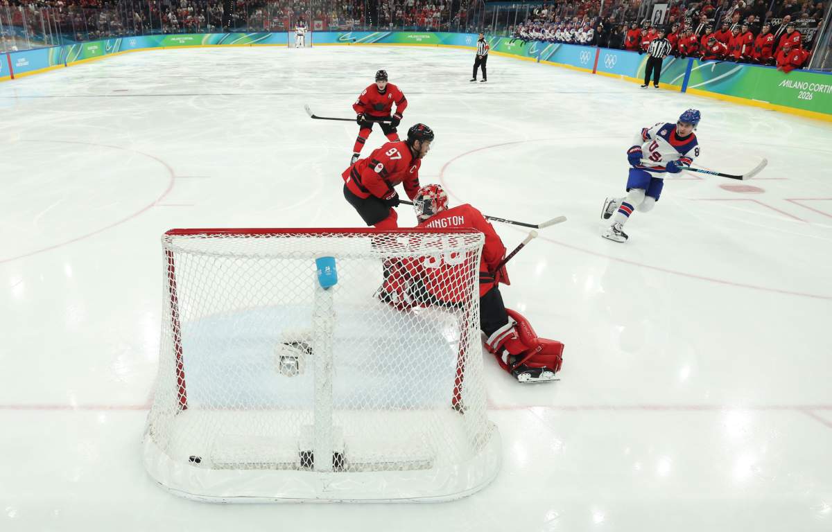 United States' Jack Hughes (86) scores the game winning goal against Canada's Connor McDavid (97) and Jordan Binnington (50) in overtime during a men's ice hockey gold medal game between Canada and the United States at the 2026 Winter Olympics, in Milan, Italy, Sunday, Feb. 22, 2026. 