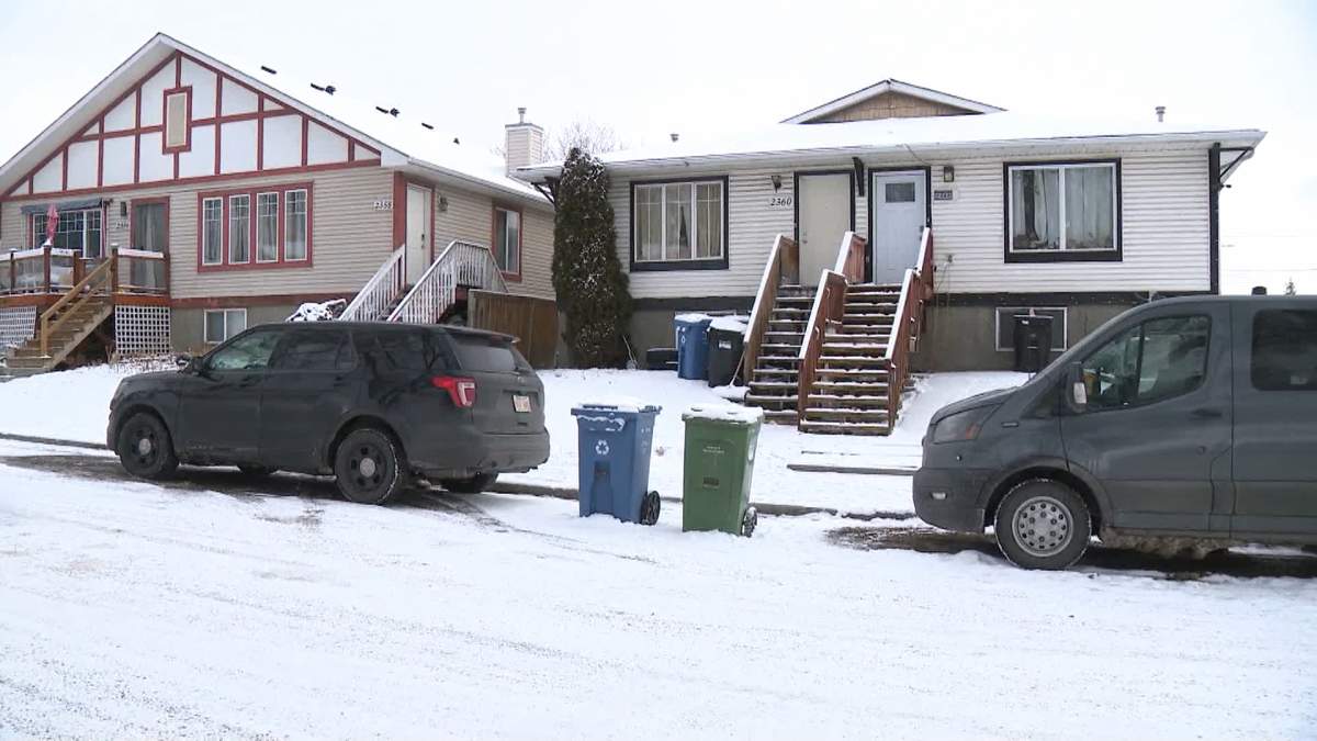 Calgary police homicide investigators are seen arriving at a house in the southeast community of Crestwood on Thursday morning after a person was taken to hospital with life-threatening injuries following an "altercation" late Wednesday.