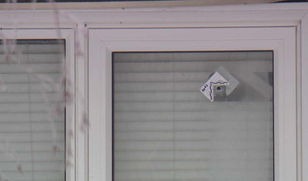 A bullet hole is seen in the window of a home in the 200 block of Martindale Boulevard, N.E., one of several that police said were fired at the home early Wednesday morning.
