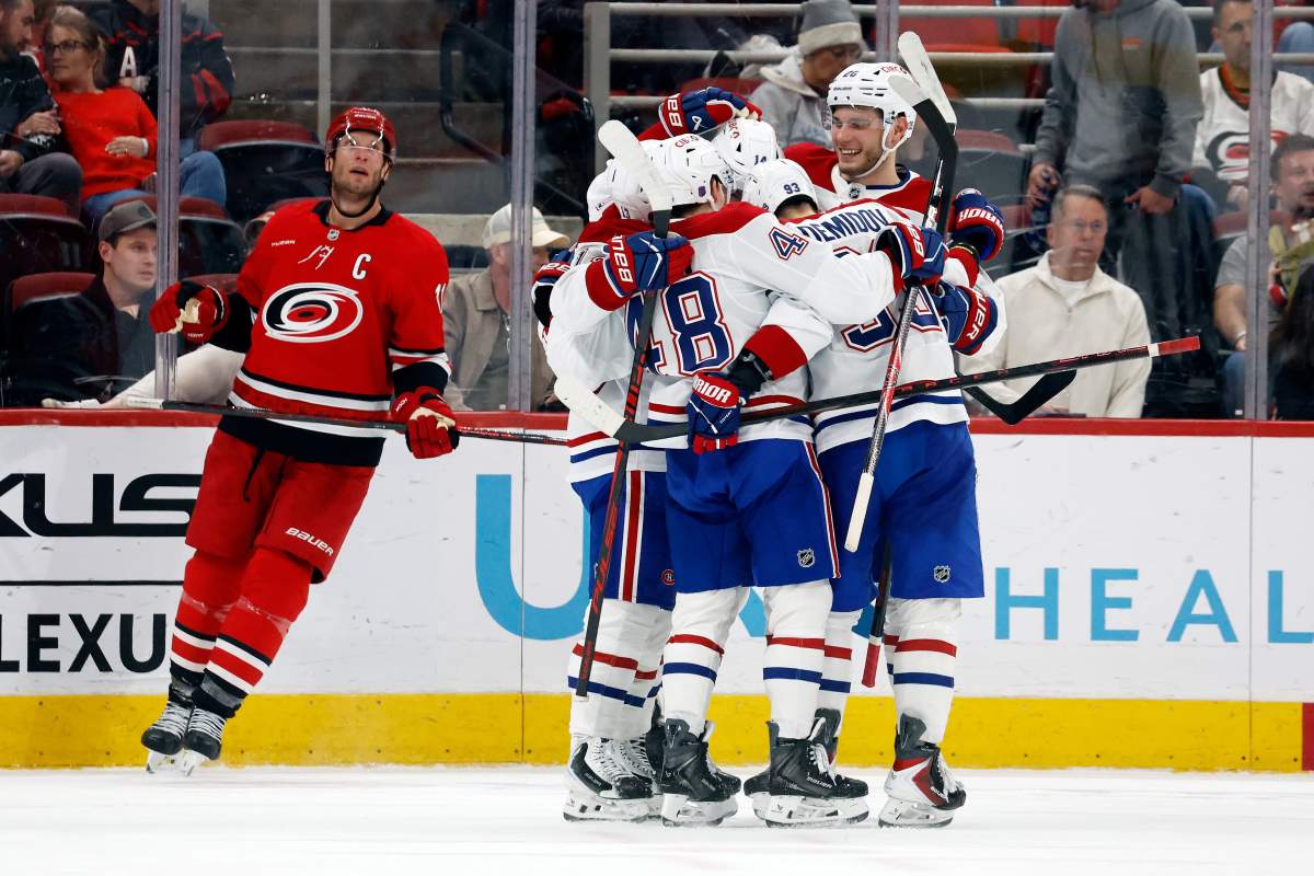 Carolina Hurricanes' Jordan Staal (11) watches the replay while the Montréal Canadiens celebrate a goal by Cole Caufield during the second period of an NHL hockey game in Raleigh, N.C., March 29, 2026. (AP Photo/Karl DeBlaker).