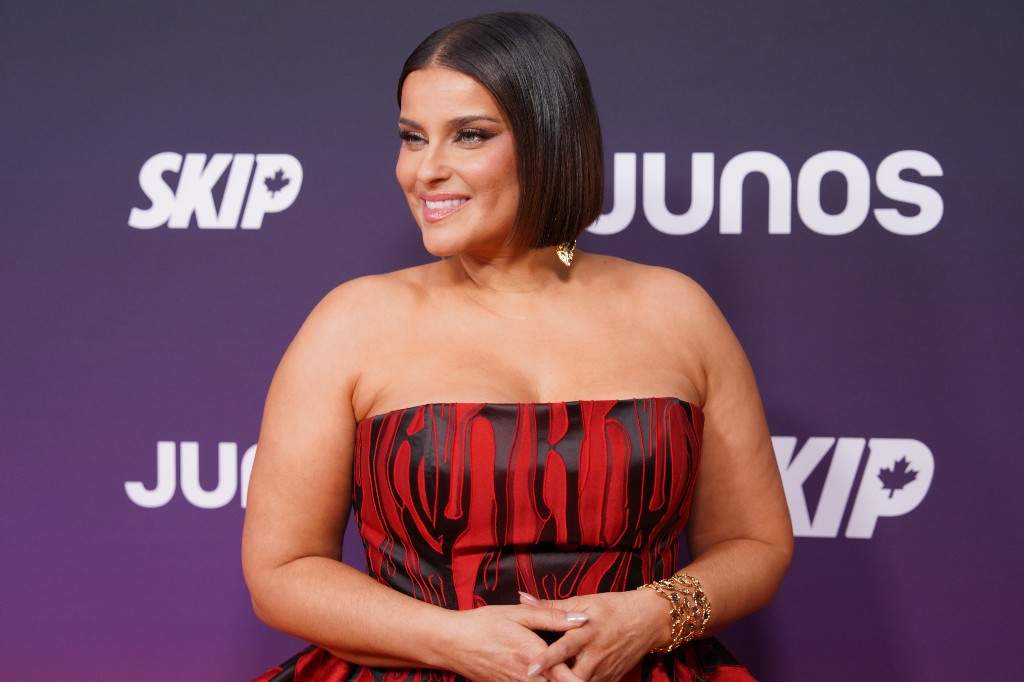 Nelly Furtado, nominated for Pop Album of the Year, and Recipient of the Canadian Music Hall of Fame honour, poses on the orange carpet at the Junos in Hamilton, Ontario, Canada on Sunday, March 29, 2026.