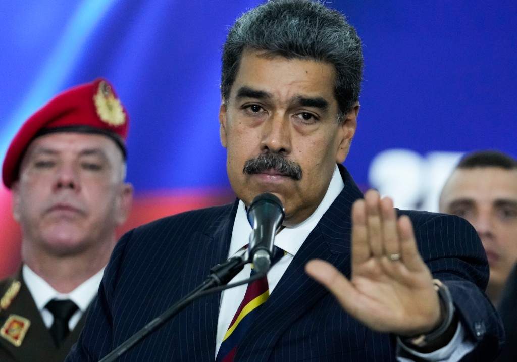 Nicolas Maduro speaks to the press before leaving the Supreme Court where he arrived for procedures related to the court's audit of presidential election results in Caracas, Venezuela, Friday, Aug. 9, 2024.