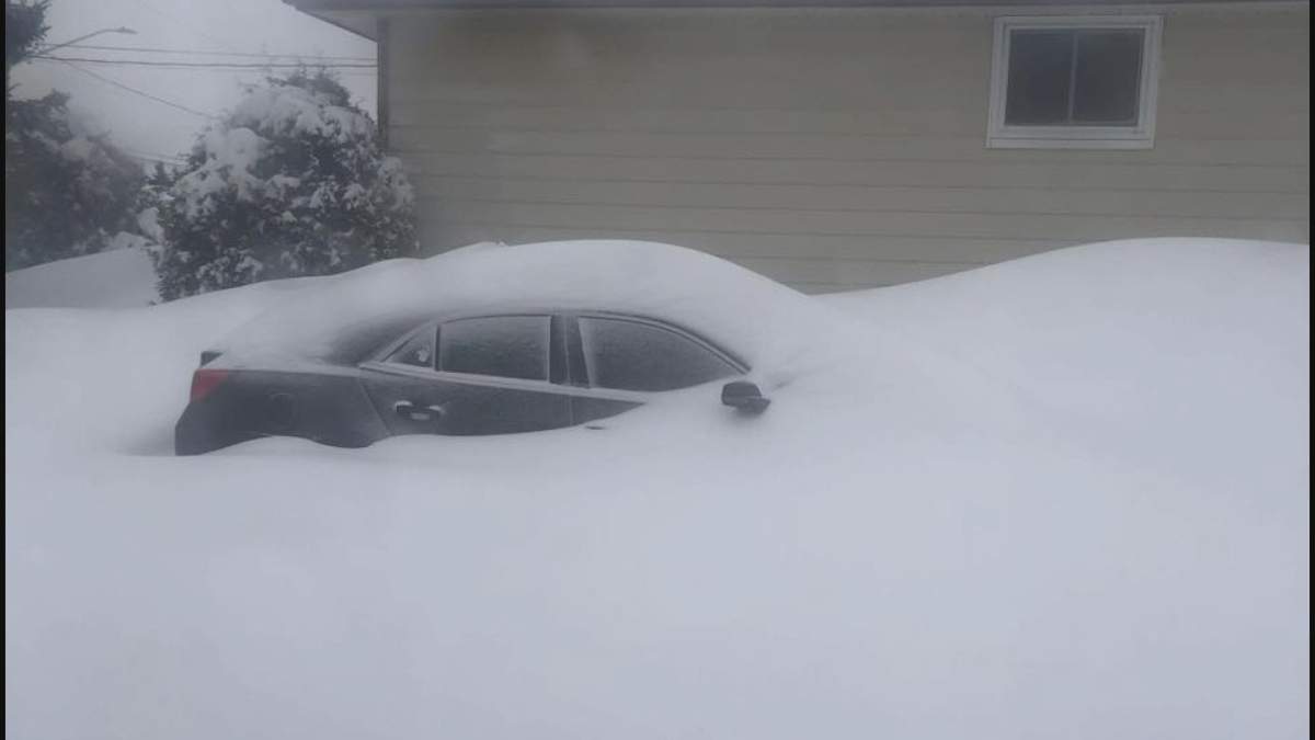 A car was seen buried in snow in Sudbury, Ont., after several centimetres fell from March 15 into 16.