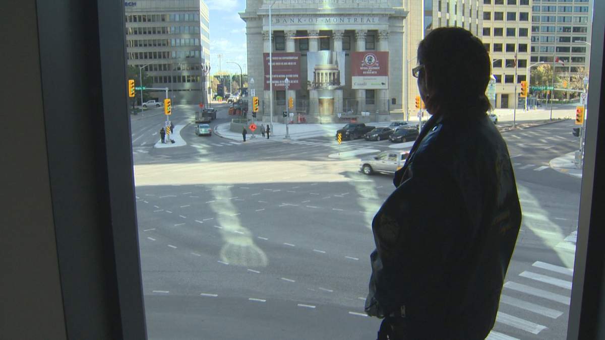 Sue Caribou looking over Portage and Main. Caribou says she will stop traffic and do a jig in the intersection the day they bring her niece home.