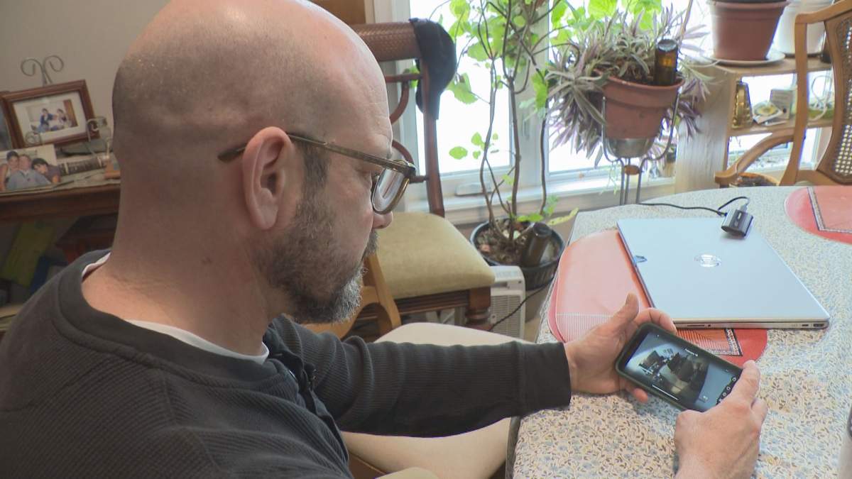 Gio Giardino looking at footage of an interaction with a home care worker that prompted him to bring his concerns to the WRHA.