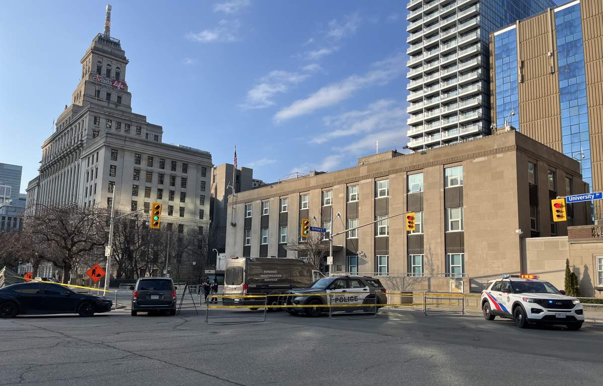 Police vehicles sit outside the U.S. Consulate in Toronto after responding to a firearm discharge earlier on Tuesday, March 10.