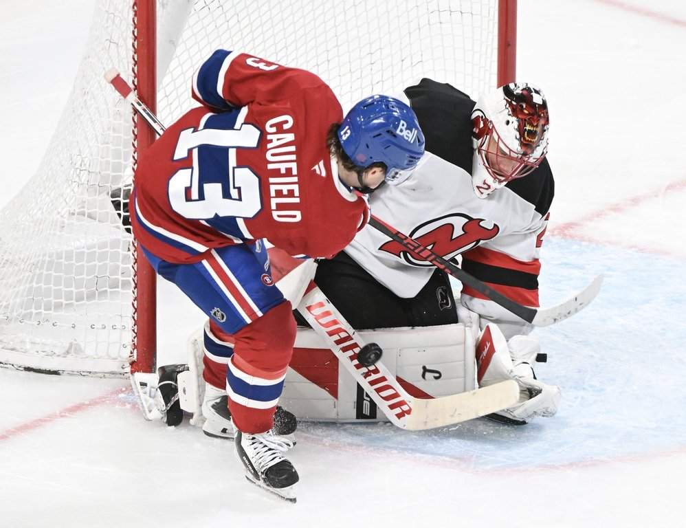 New Jersey Devils goaltender Jacob Markstrom stops  Montreal Canadiens' Cole Caufield (13) during third period NHL hockey action in Montreal, Sunday, April 5, 2026. THE CANADIAN PRESS/Graham Hughes.