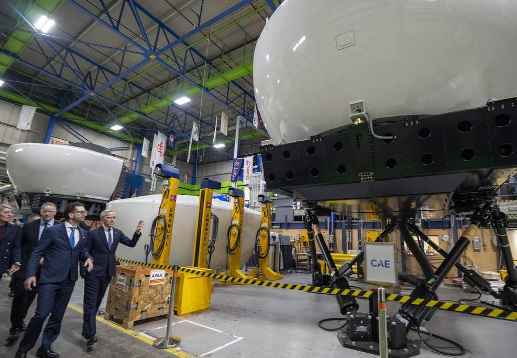 Prime Minister Mark Carney, right, and CAE Inc. chief executive Matthew Bromberg tour company facilities in Montreal, on Tuesday, Feb. 17, 2026. THE CANADIAN PRESS/Christinne Muschi.