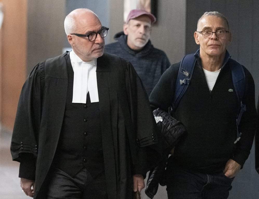Richard Gauthier, right, a former Canadian pairs skating coach, who was found guilty of sexual assault, gross indecency, arrives for sentencing at the Montreal courthouse with his lawyer Giuseppe Battista in Montreal, Monday, Nov. 6, 2023.