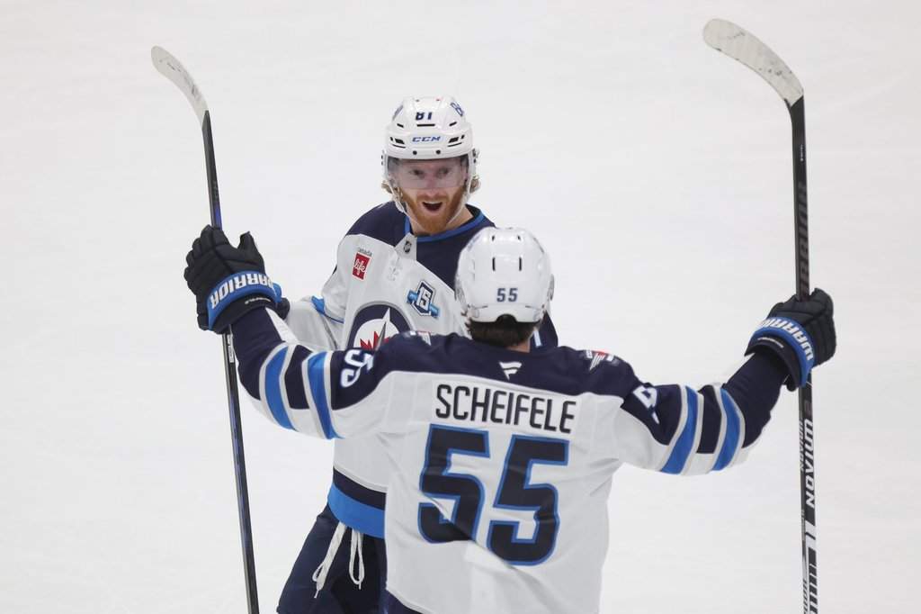 Winnipeg Jets forward Kyle Connor, left, celebrates with teammate forward Mark Scheifele after Conner's goal against the Columbus Blue Jackets during the third period of an NHL hockey game in Columbus, Ohio, Saturday, April 4, 2026.