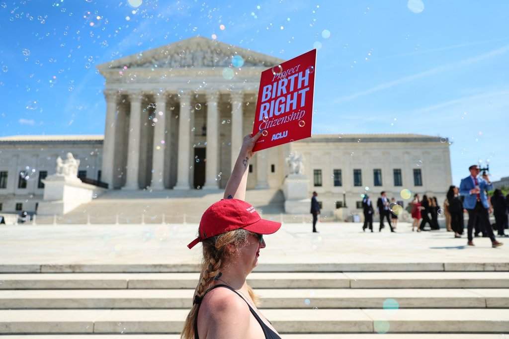 Demonstrators rally outside the U.S. Supreme Court after justices hear oral arguments on whether President Donald Trump can deny citizenship to children born to parents who are in the United States illegally or temporarily, on Capitol Hill in Washington, Wednesday, April 1, 2026. (AP Photo/Tom Brenner).