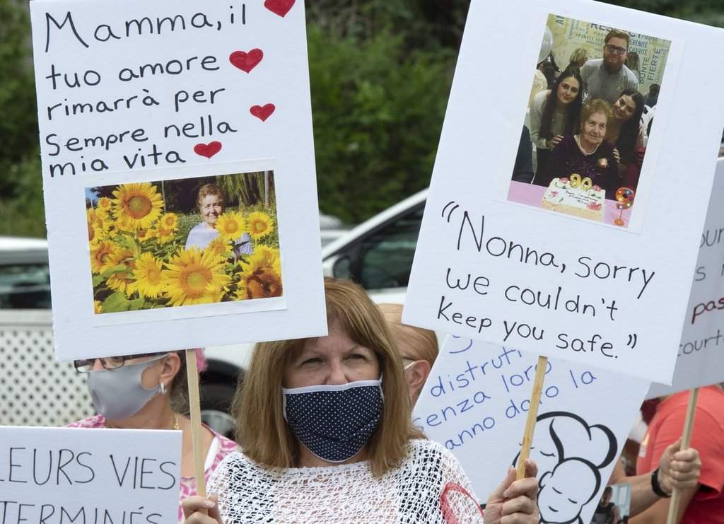 Family and friends of the residents that died from COVID-19 related causes take part in a memorial in front of the Residence Angelica seniors home Thursday, July 23, 2020 in Montreal. 