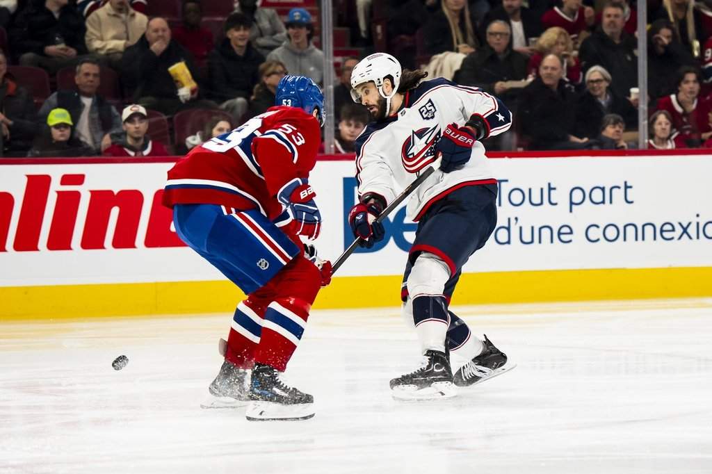 Columbus Blue Jackets' Kirill Marchenko (27) shoots past Montreal Canadiens' Noah Dobson (53) to score during second period NHL hockey action in Montreal on Saturday, April 11, 2026. THE CANADIAN PRESS/Christopher Katsarov.