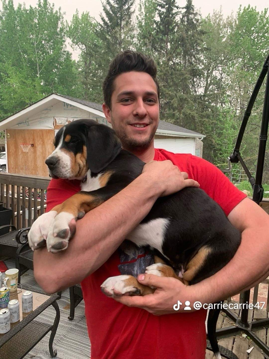 Brayden Balkwill holding a small puppy
