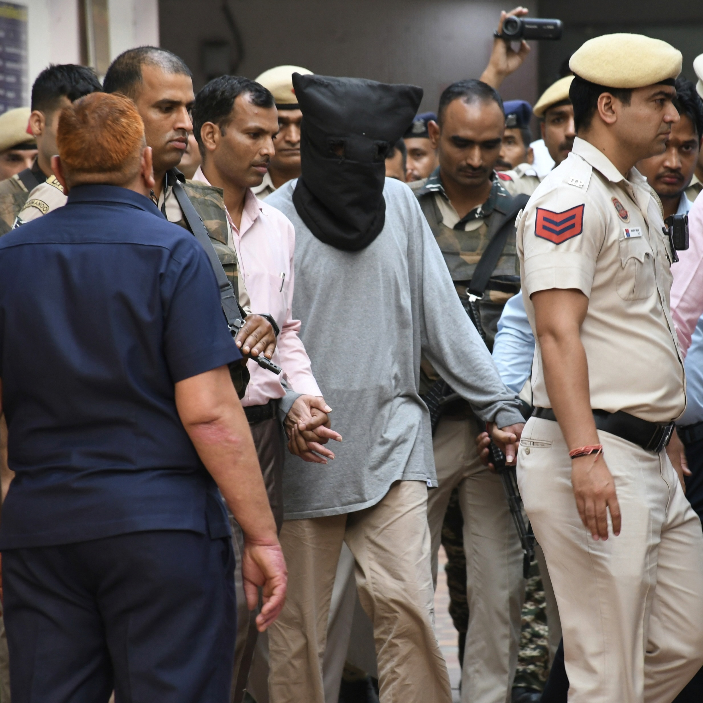 Canadian citizen Tahawwur Hussain Rana is escorted to court, New Delhi, India, April 28, 2025, after his extradition from the US. (AP Photo/Dinesh Joshi)