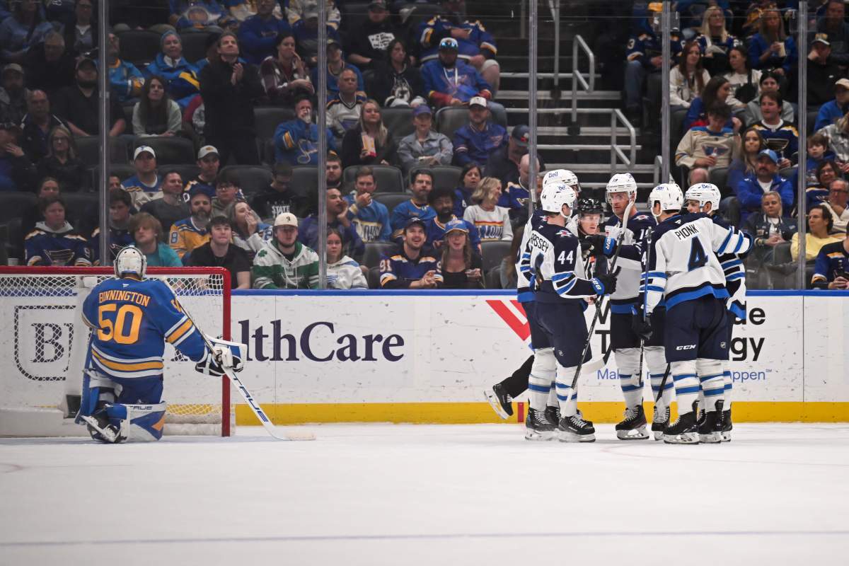 Winnipeg Jets' Jonathan Toews is congratulated by teammates after scoring a goal against the St. Louis Blues during the second period of an NHL hockey game Thursday, April 9, 2026, in St. Louis. (AP Photo/Connor Hamilton).