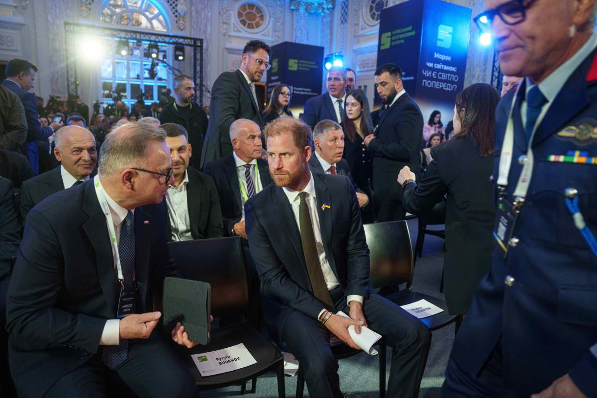 Britain's Prince Harry, centre, and of Poland's Former President Andrzej Duda, left, talk at the Security Forum in Kyiv, Ukraine, on Thursday, April 23, 2026.