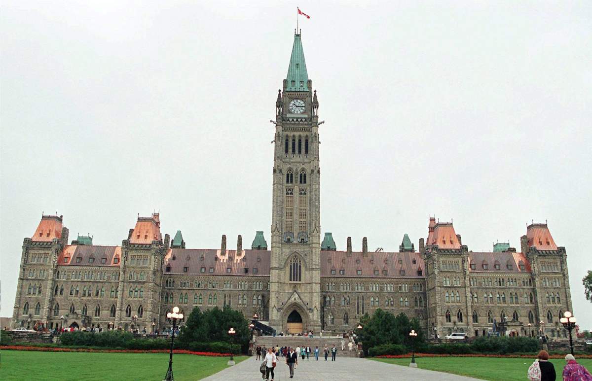 File photo from 1997, when new sections of copper roof were installed at the Centre Block of Parliament Hill, contrasting with the older green sections of the Peace Tower.