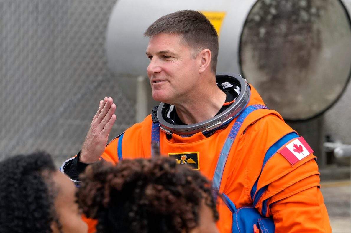 Mission Specialist Jeremy Hansen, of Canada, blows a kiss to family members as he leaves the Operations and Checkout Building for a trip to Launch Pad 39-B and a planned liftoff on NASA’s Artermis II moon rocket at the Kennedy Space Center Wednesday, April 1, 2026, in Cape Canaveral, Fla. (AP Photo/Chris O’Meara)