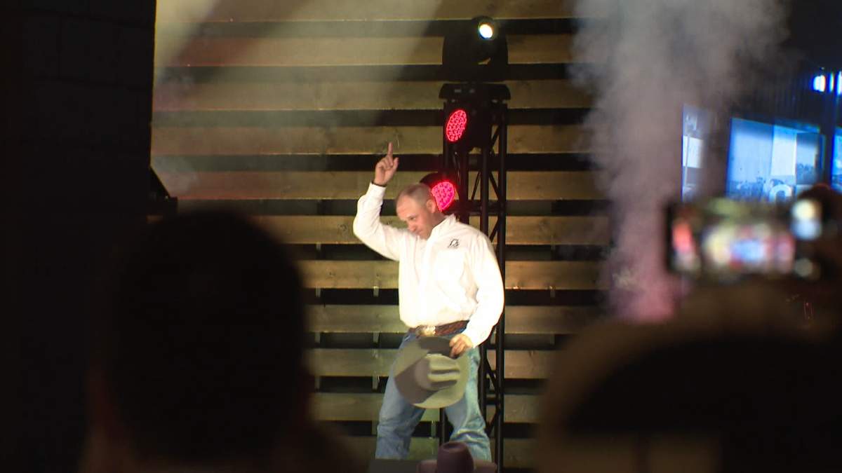 Chuckwagon driver Rae Croteau Jr. celebrates after setting a new record bid for a single canvas at this year's Calgary Stampede canvas auction.