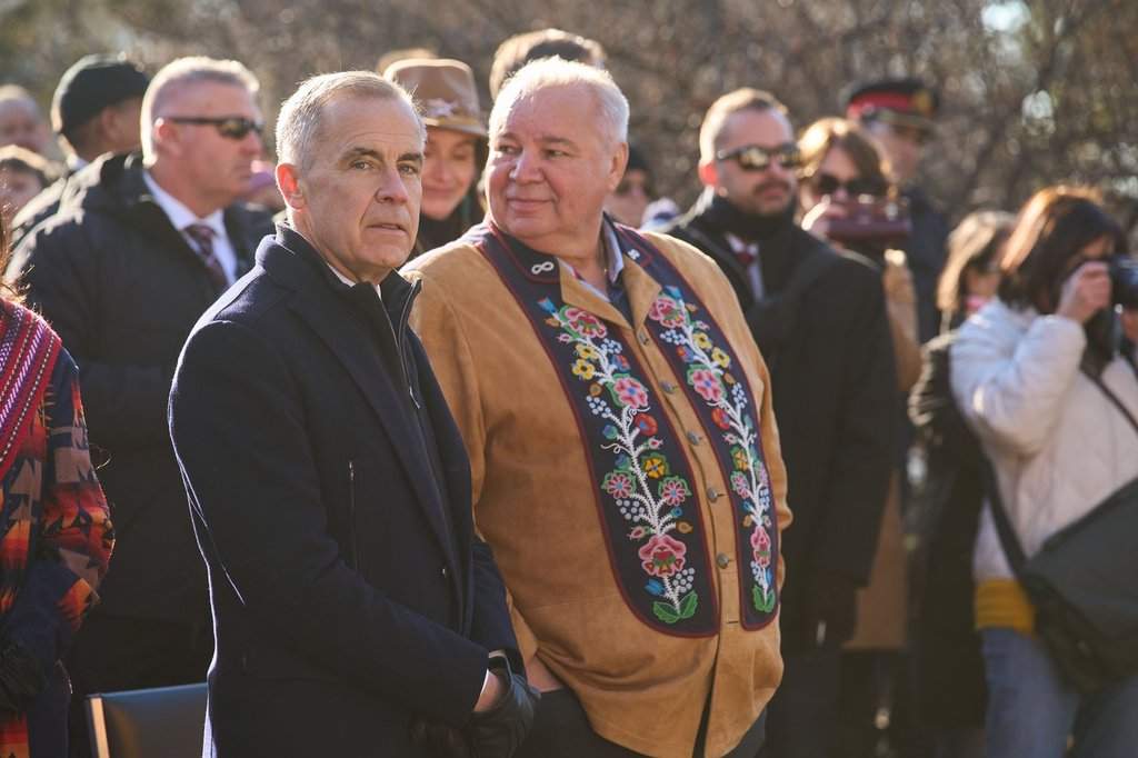 Prime Minister Mark Carney, left, and Manitoba Métis Federation President David Chartrand speak together at the Louis Riel Commemoration Event in Winnipeg on Sunday Nov. 16, 2025 at the Saint Boniface Cathedral. THE CANADIAN PRESS/David Lipnowski