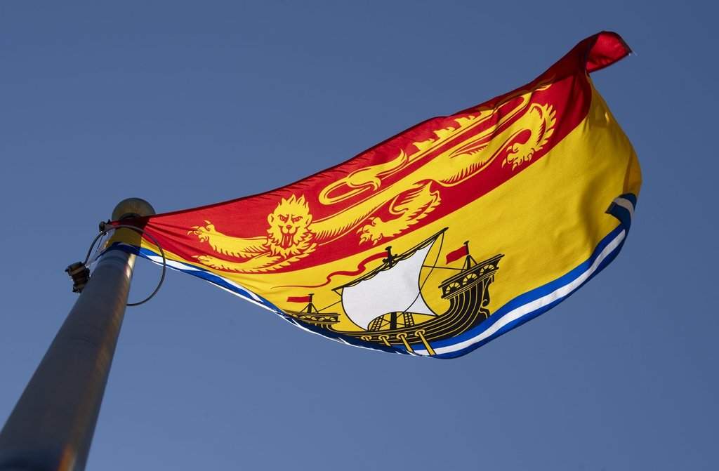 New Brunswick's provincial flag flies on a flagpole in Ottawa, Monday July 6, 2020. THE CANADIAN PRESS/Adrian Wyld.