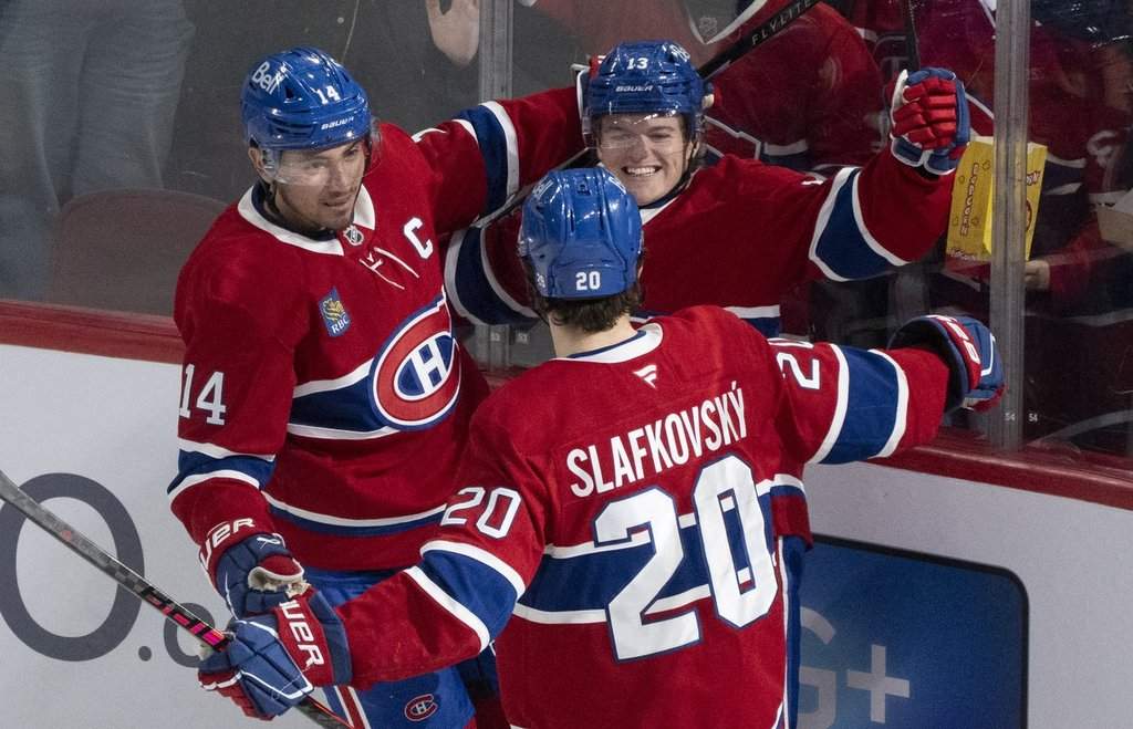 Montreal Canadiens' Cole Caufield (13) celebrates his goal with teammates Nick Suzuki (14) and Juraj Slafkovsky (20) during second period NHL hockey action against the Anaheim Ducks, in Montreal on Sunday, March 15, 2026. 