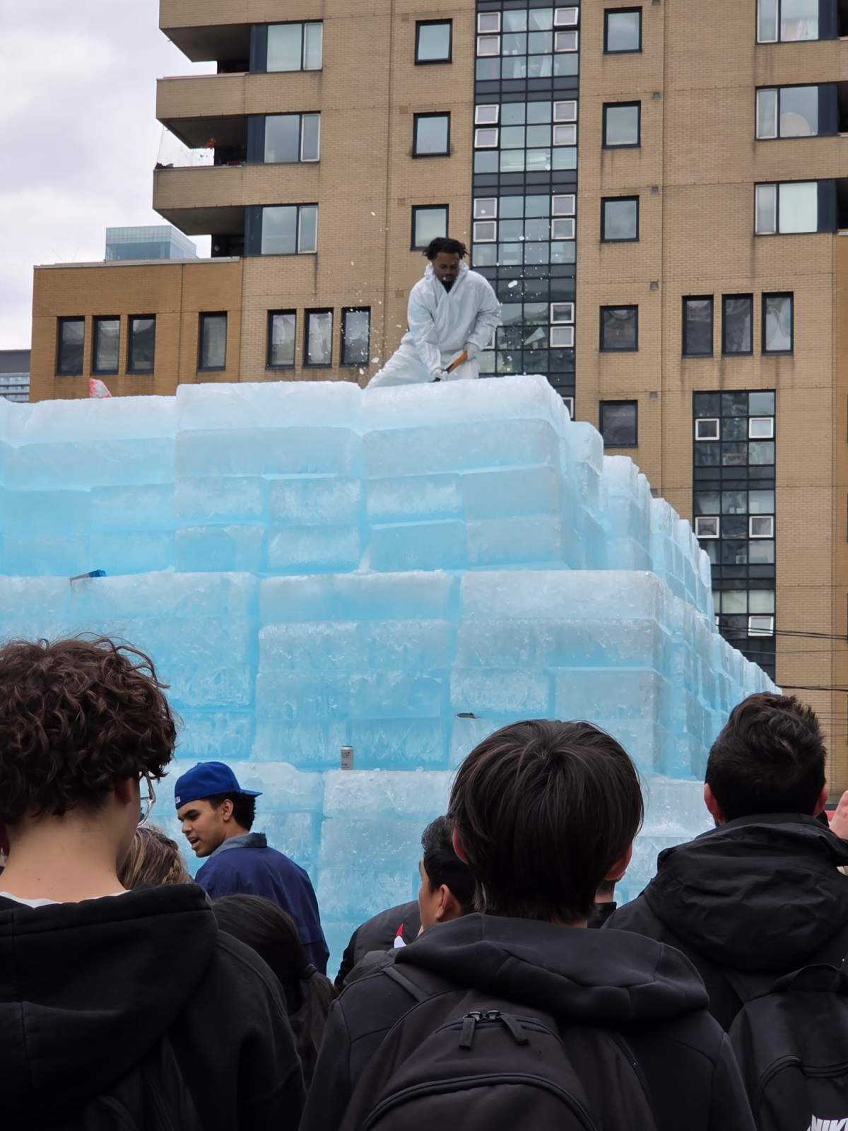 A man brings down a pickaxe on top of an ice sculpture being used to promote Drake’s upcoming album.