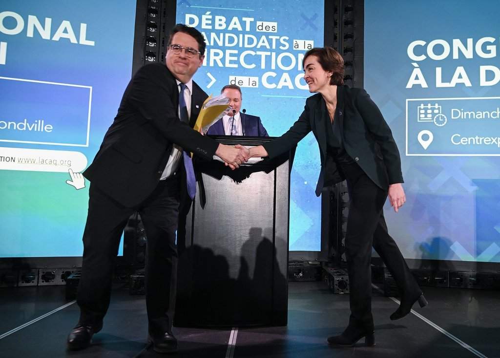 Coalition Avenir Québec (CAQ) leadership candidates Christine Frechette and Bernard Drainville shake hands following a leadership debate in Laval, Que., Saturday, March 28, 2026. THE CANADIAN PRESS/Graham Hughes.